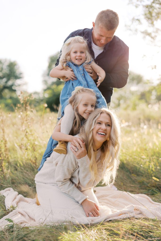 a family laughs together at their family photo shoot in Lakeville, MN.
