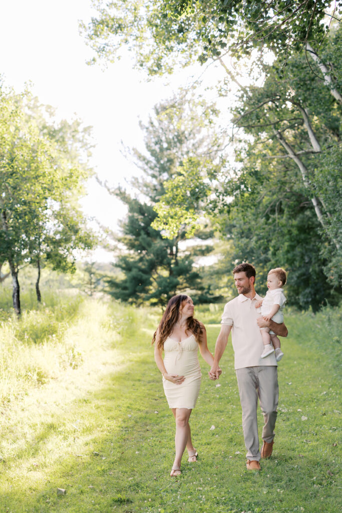 a family holds hands during family photos at Ritter Farm Park in Lakeville.