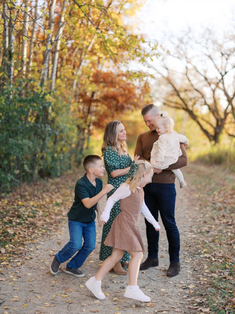a family plays together on a fall evening with Lakeville Family Photographer Morgan Walworth.