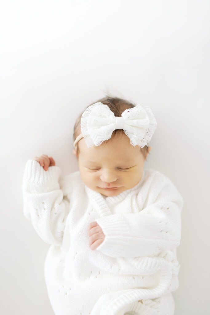 a baby girl smiles in her sleep during her Edina Newborn Photo Session with Morgan Walworth Photography.