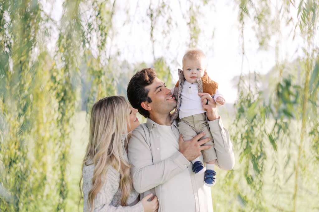 a family smiles at their child during their family photos in Lakeville, MN.