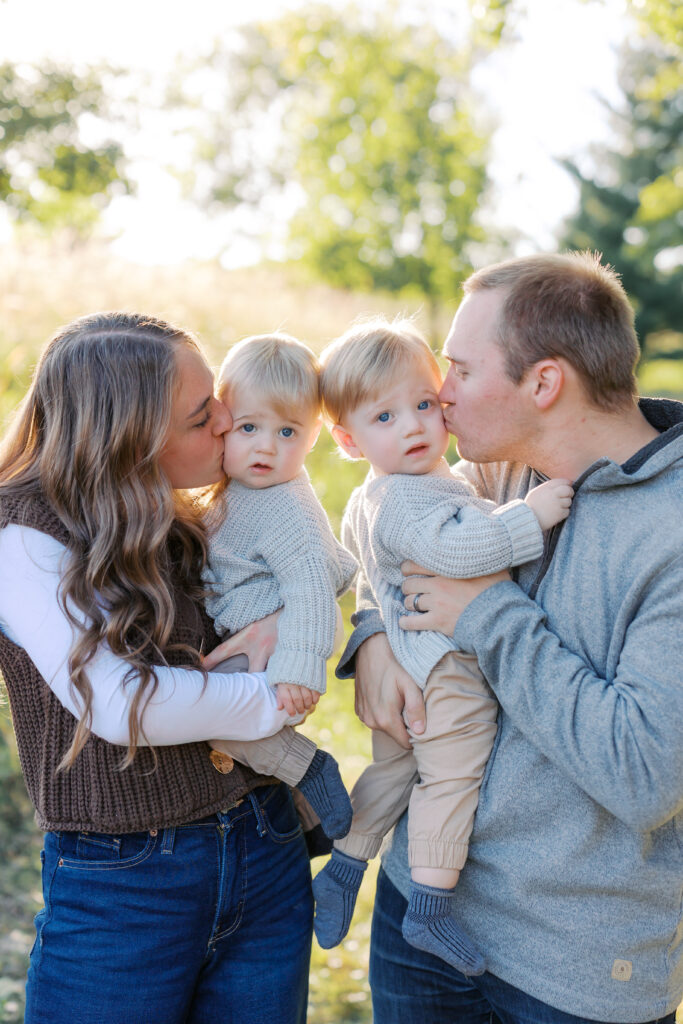 a family kisses their twins at their Lakeville Family Photos.