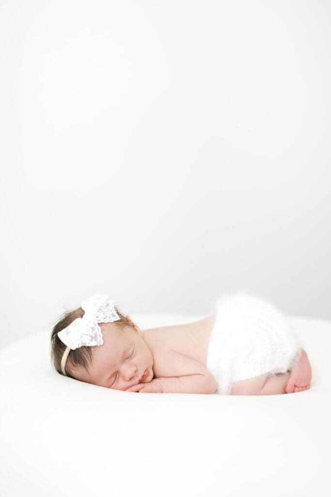 a baby girl sleeps during her baby photos with Minneapolis Newborn Photographer Morgan Walworth.