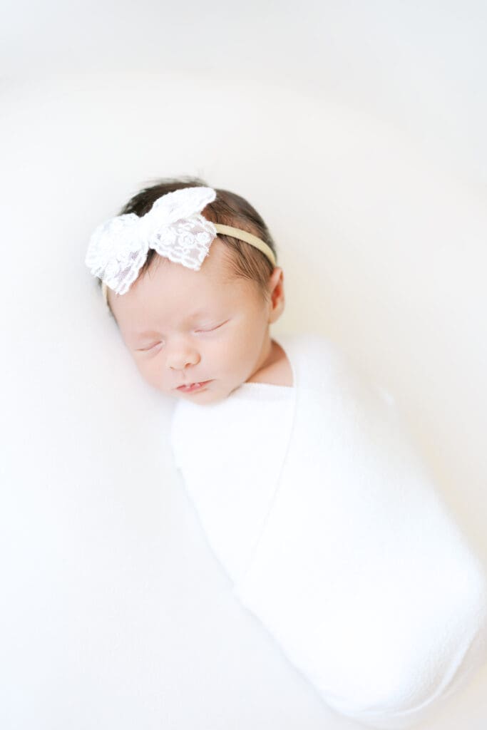 a baby girl sleeps during photos with Minneapolis Newborn Photographer.