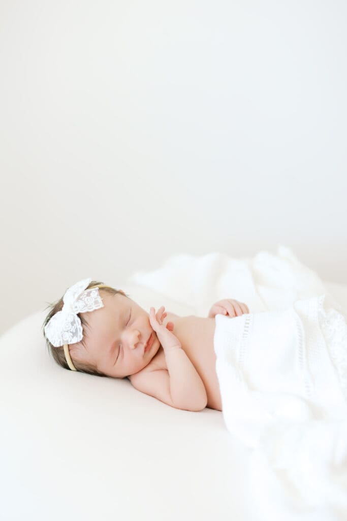 a baby sleeps at her newborn photoshoot with Minneapolis Newborn Photographer, Morgan Walworth.