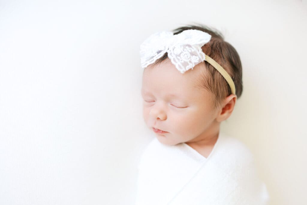 a baby girl sleeps during her newborn photos in Minneapolis, MN.
